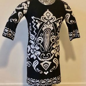 Fun dress with a pop of tan pattern and beads.